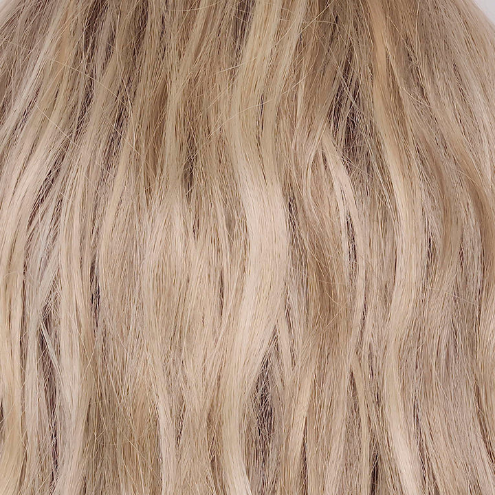 Buttercream Blond-R | The rooted sister of Buttercream Blond is a stunning baby blond shade with a warm chocolate root that exudes elegance and sophistication. This exquisite hair color is meticulously crafted with an array of tonal blond tones, seamlessly woven to perfection. The harmonious blend of light ash, medium honey, and pale gold hues creates a luxurious and radiant finish, giving this shade a touch of class and the perfect balance of blond tones.