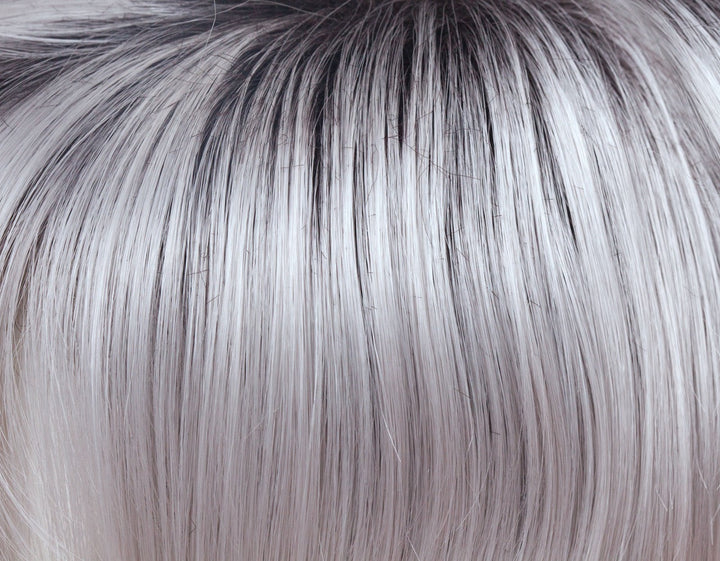 Illumina-R | This striking iridescent white gives off hues of silver and pales purples. The dark brown root has an appearance of natural regrowth.