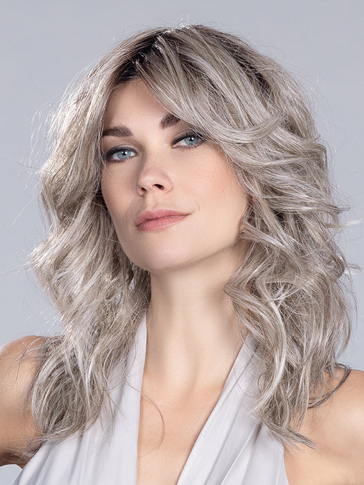 Voice (styled: Wavy) in Stone Grey Rooted 58.51.56 | Grey with Black/Dark Brown and Lightest Blonde Blend